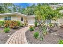 Inviting front entrance featuring a brick walkway and lush landscaping at 6343 Hollywood Blvd, Sarasota, FL 34231