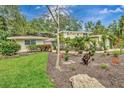 Charming single-Gathering home featuring well-maintained landscaping and vibrant foliage at 6343 Hollywood Blvd, Sarasota, FL 34231