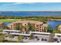 Gorgeous condo building with lush landscaping, covered parking, golf course and lovely water view at 6509 Grand Estuary Trl # 203, Bradenton, FL 34212