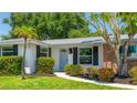 Close-up of the front of the house with a brick accent wall and a well maintained front lawn at 6529 Seagate Ave, Sarasota, FL 34231