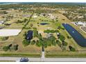 Expansive aerial view showcasing the property's vast land, serene ponds, and equestrian facilities at 6605 253Rd St E, Myakka City, FL 34251