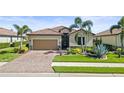A beautifully landscaped single-Gathering home with a tile roof and a two-car garage at 7120 Quiet Creek Dr, Bradenton, FL 34212
