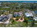 Beautiful aerial view showcasing the home's layout, circular driveway, and the surrounding landscape at 7333 Point Of Rocks Rd, Sarasota, FL 34242