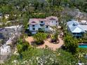 Expansive aerial view of the property, highlighting the home's setting amidst lush greenery and mature trees at 7333 Point Of Rocks Rd, Sarasota, FL 34242