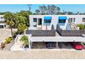 Well maintained condo exterior, showcasing private balcony areas, parking, and lush tropical landscaping at 750 Bayport Way # 750, Longboat Key, FL 34228