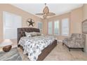 Cozy main bedroom features a plush bed, ceiling fan and shuttered windows at 7624 Boltons Ct, Bradenton, FL 34201