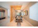 Bright dining room boasts a modern chandelier, glass dining table, and an open-concept layout at 816 Goodrich Ave, Sarasota, FL 34236