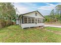 Quaint home with gravel driveway, fenced yard, and black trim, offering a classic and inviting aesthetic at 1016 38Th W St, Bradenton, FL 34205