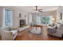 Bright living room featuring a fireplace, plush seating, and sliding glass doors to a private balcony for indoor-outdoor enjoyment at 111 Tidy Island Blvd # 111, Bradenton, FL 34210