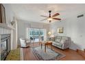 Bright living room featuring a fireplace, plush seating, and sliding glass doors to a private balcony for indoor-outdoor enjoyment at 111 Tidy Island Blvd # 111, Bradenton, FL 34210