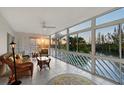 Inviting sunroom filled with natural light, showcasing wicker furniture and serene water views, perfect for relaxation at 111 Tidy Island Blvd # 111, Bradenton, FL 34210