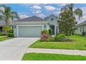 Charming home with a well-manicured lawn, flowering shrubbery, and a two car garage at 12330 Halfmoon Lake Ter, Bradenton, FL 34211