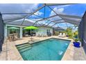 Inviting screened-in pool with beautiful patio furniture, landscaping, and sunny views at 12330 Halfmoon Lake Ter, Bradenton, FL 34211