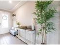 Bright foyer with a console table, bench seating, and a decorative tree at 13422 Flat Woods Ter, Bradenton, FL 34211
