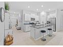 Open kitchen with granite countertops, stainless steel appliances, and a breakfast bar at 13422 Willow Bluestar Loop, Riverview, FL 33579