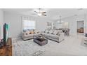 Bright living room featuring tile floors, neutral walls, two couches and a center coffee table with decor at 13422 Willow Bluestar Loop, Riverview, FL 33579