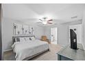 Bright main bedroom featuring a ceiling fan, ensuite bathroom and neutral walls at 13422 Willow Bluestar Loop, Riverview, FL 33579