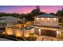 Charming exterior featuring a well-lit facade, private fence, and lush landscaping around the property at 1559 Bay Rd, Sarasota, FL 34239