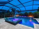 An inviting screened-in pool and hot tub, complete with lighting and views of the lake at 16614 Berwick Ter, Lakewood Ranch, FL 34202