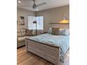 Comfortable bedroom featuring a queen bed, couch, and bright lighting at 170 Roosevelt Dr # 5, Sarasota, FL 34236