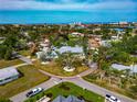 Aerial view of the house surrounded by a circular driveway, mature trees, and lush landscaping at 1722 Hazelwood St, Sarasota, FL 34231