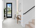 Bright and airy entryway featuring modern console table, decor and staircase at 2249 Oak Terrace St, Sarasota, FL 34231