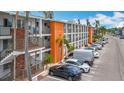 Exterior view of condo building with staircases, palm trees, and parking spaces at 2321 Canal Dr # F25, Bradenton, FL 34207