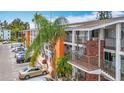 Exterior shot of condo units featuring brick stairways, walkways, and mature palm trees at 2321 Canal Dr # F25, Bradenton, FL 34207