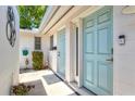 Charming courtyard entrance with dual front doors, freshly painted, and decorative potted plants at 2435 Terry Ln, Sarasota, FL 34231