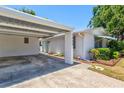 Quaint single-story home boasts a covered carport, freshly painted exterior and manicured landscaping at 2435 Terry Ln, Sarasota, FL 34231
