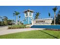 Beachwalk by Manasota Key community entrance with blue tower, landscaping, and community sign at 26017 Seastone Dr, Englewood, FL 34223