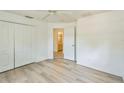 Bedroom featuring wood-look flooring, and a closet, with the bathroom visible through the doorway at 3204 Pericles Ave, North Port, FL 34286