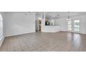 Bright, spacious living room featuring tile floors, ceiling fan, and neutral-colored walls at 3204 Pericles Ave, North Port, FL 34286