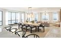 Elegant dining area with a large table, modern chairs, and views of the living space and water beyond at 33 S Palm Ave # 1501, Sarasota, FL 34236