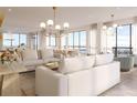 Open concept living and dining area with stunning water views through large windows and modern lighting at 33 S Palm Ave # 1501, Sarasota, FL 34236