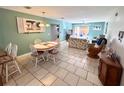 Open-concept dining area with seating for six and views of the adjacent living room at 3473 Clark Rd # 171, Sarasota, FL 34231