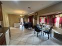 Bright dining area with tile floors, chandelier, and natural light from the bay window at 4111 34Th St E, Bradenton, FL 34208