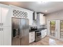 Modern kitchen boasts stainless steel appliances, granite counters, and subway tile backsplash, with french door access to yard at 4347 9Th N Ave, St Petersburg, FL 33713