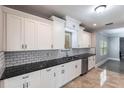Updated kitchen features white cabinets, granite countertops, stainless steel appliances and subway tile backsplash at 4347 9Th N Ave, St Petersburg, FL 33713