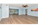 Bright open-concept living room with recessed lighting, ceiling fan, light walls, and attractive wood-look floors at 4512 26Th S Ave, Tampa, FL 33619