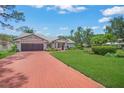 Charming single story home featuring a brick driveway, a two car garage, and lush landscaping at 4636 Pine Harrier Dr, Sarasota, FL 34231