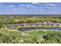 A community aerial view of properties surrounding a scenic lake and a golf course at 5217 Chase Oaks Dr, Sarasota, FL 34241
