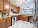 Kitchen with stainless steel appliances, wood cabinets, and granite countertops at 5234 Lake Arrowhead Trl # 30, Sarasota, FL 34231