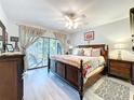 Spacious main bedroom featuring a large bed, a ceiling fan, and access to the home's lanai at 5234 Lake Arrowhead Trl # 30, Sarasota, FL 34231