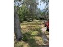 Wide front lawn, charming well structure, and inviting home exterior create a tranquil and picturesque setting at 6013 Idle A While Cir, Dade City, FL 33523