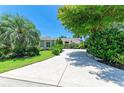Lush trees and greenery accent this lovely home with a long, inviting driveway at 6102 Sonesta Ct, Bradenton, FL 34202