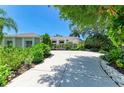 Attractive single Gathering home with manicured landscaping, mature trees, and a long driveway at 6102 Sonesta Ct, Bradenton, FL 34202