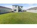 Large, well-maintained backyard featuring lush green grass, a privacy fence, and ample space for outdoor activities at 6314 Distant Haze Pl, Palmetto, FL 34221