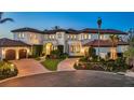 Beautiful mediterranean-style home with well manicured lawn, a circular drive, and a separate garage at 641 Ranger Ln, Longboat Key, FL 34228