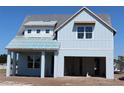Beautiful two-story home featuring light blue siding and an attached two-car garage at 658 Maldives Trl, Sarasota, FL 34234